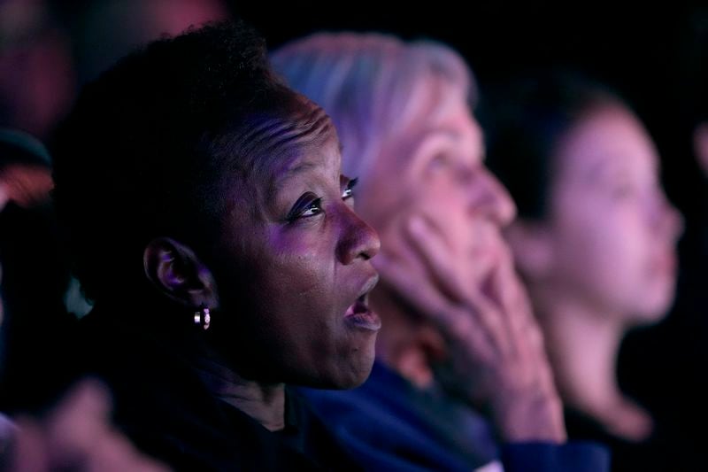 People watch the presidential debate between Republican presidential nominee former President Donald Trump and Democratic presidential nominee Vice President Kamala Harris at the Aztec theater Tuesday, Sept. 10, 2024, in Shawnee, Kan. (AP Photo/Charlie Riedel)