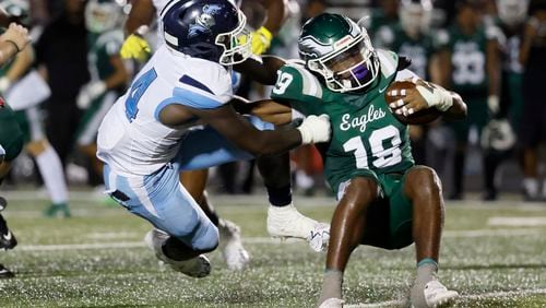 Cedar Grove linebacker Keith Bass (24) tackles Collins Hill running back Jacarri Thomas (19) after a short gain during the first half of their game at Collins Hill High School, Friday, September 9, 2022, in Suwanee. (Jason Getz / Jason.Getz@ajc.com)