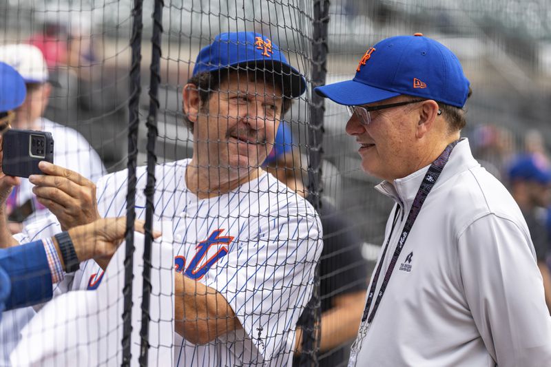 New York Mets owner Steve Cohen, right, poses with a fan for a photo before the start of a baseball game against the Atlanta Braves, Monday, Sept. 30, 2024, in Atlanta. (AP Photo/Jason Allen)