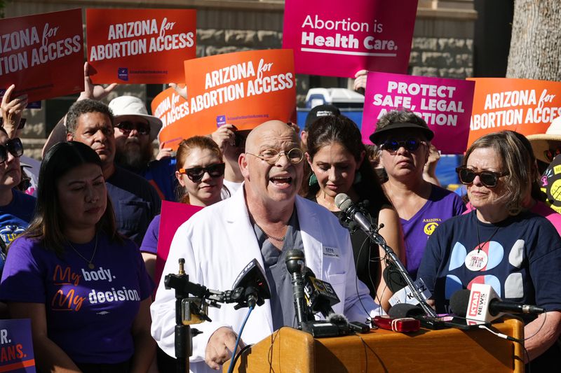 Dr. Paul Isaacson speaks as Arizona abortion-rights supporters gather for a news conference prior to delivering over 800,000 petition signatures to the capitol to get abortion rights on the November general election ballot Wednesday, July 3, 2024, in Phoenix. (AP Photo/Ross D. Franklin)