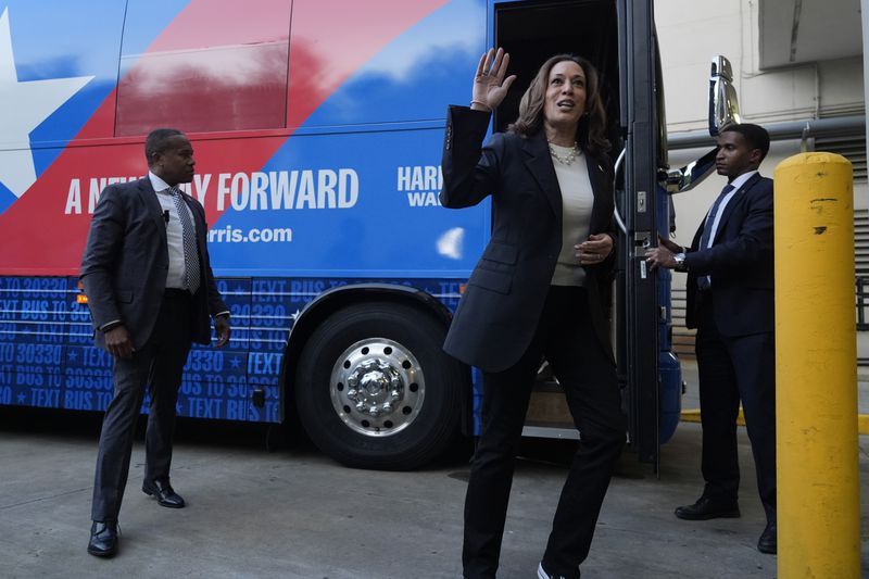 Democratic presidential nominee Vice President Kamala Harris waves as she exits her campaign bus in Savannah, Ga., Wednesday, Aug. 28, 2024. (AP Photo/Jacquelyn Martin)