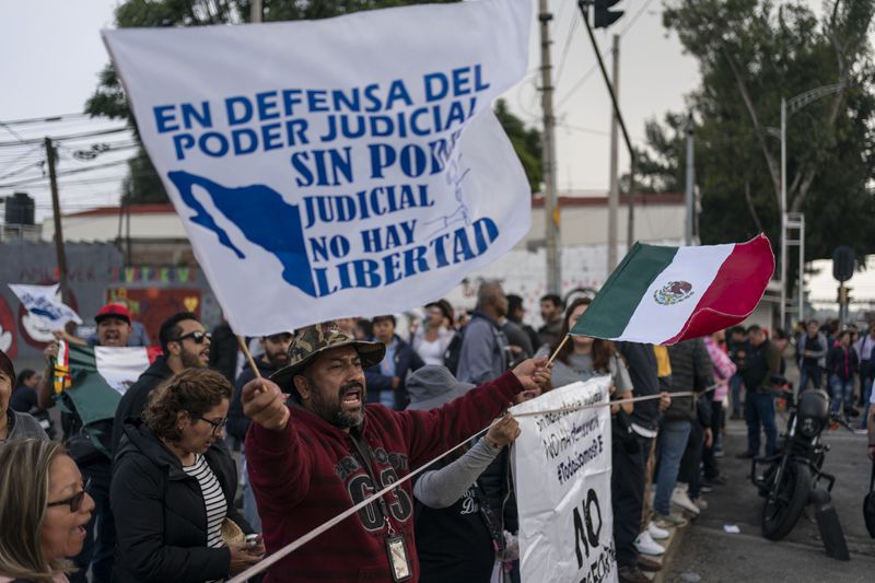 Protesters block entrances to Congress over constitutional reform proposals that would make judges stand for election in Mexico City, Tuesday, Sept. 3, 2024. (AP Photo/Felix Marquez)