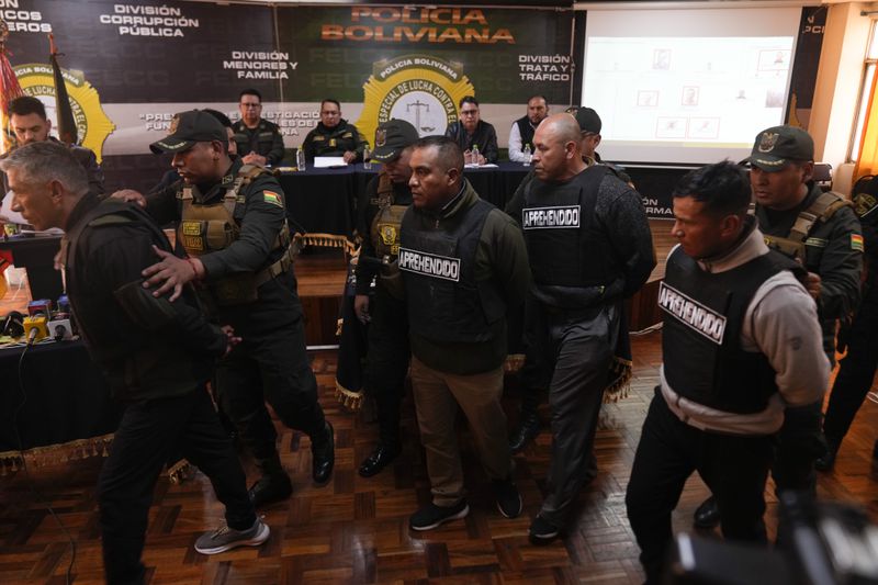 People arrested in connection with the previous day's uprising are presented by the police to the press in La Paz, Bolivia, Thursday, June 27, 2024. The government announced more arrests over their alleged involvement in what President Luis Arce called a coup attempt. (AP Photo/Juan Karita)