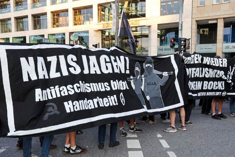 Participants in a demonstration against the right hold a banner with the slogan "Hunt Nazis! Anti-fascism remains manual labor" in Hamburg, Sunday, Sept. 1, 2024. (Bodo Marks/dpa via AP)