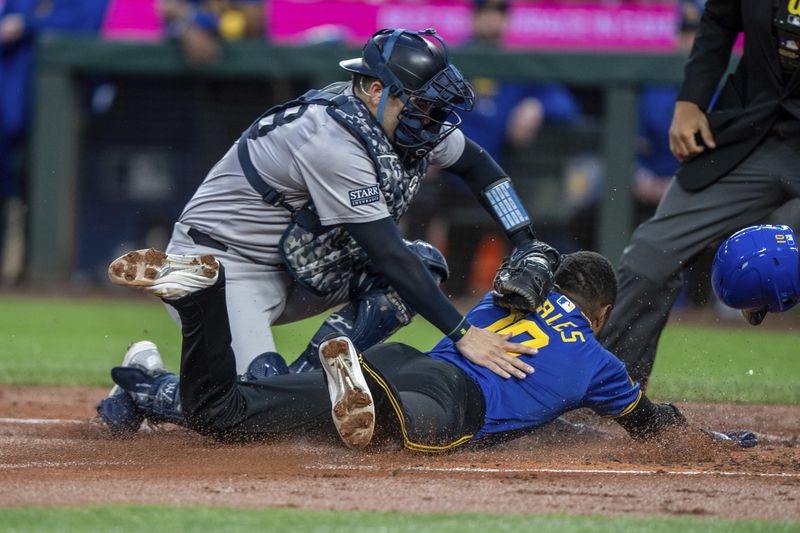 New York Yankees catcher Austin Wells tags out Seattle Mariners' Victor Robles attempting to steal home plate during the first inning of a baseball game, Tuesday, Sept. 17, 2024, in Seattle. (AP Photo/Stephen Brashear)