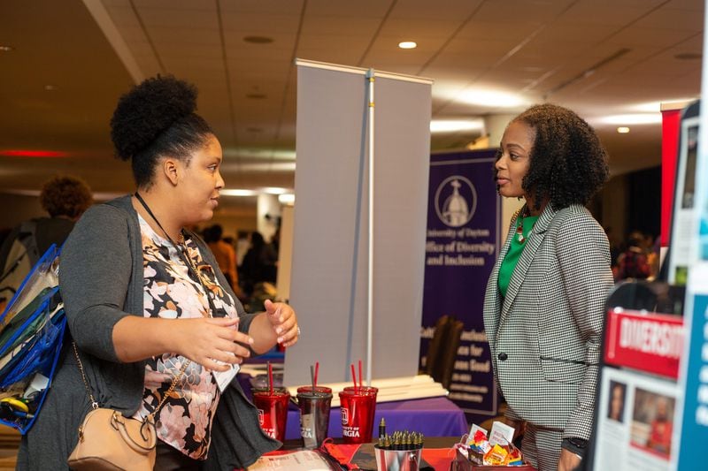 Georgia State is not alone in wanting to get more nonwhite and female students to teach on college campuses. Shonte Matthews, the assistant director of faculty and staff initiatives at the University of Georgia’s Office of Institutional Diversity, speaks to a conference attendee at the Marriott Marquis in downtown Atlanta on Friday, Oct. 25, 2019. An estimated 1,200 educators, college recruiters and students met at the Marriott Marquis this weekend as part of the Southern Regional Education Board-led Institute on Teaching and Mentoring. REBECCA WRIGHT / FOR THE ATLANTA JOURNAL-CONSTITUTION