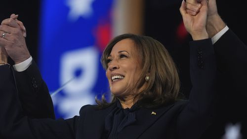 Democratic presidential nominee Vice President Kamala Harris celebrates with her families as the balloons fall during the final day of during the Democratic National Convention Thursday, Aug. 22, 2024, in Chicago. (AP Photo/Erin Hooley)