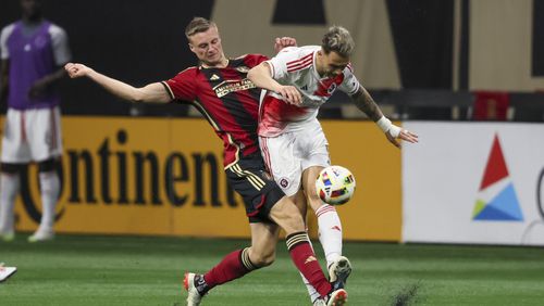 Atlanta United defender Stian Gregersen (5) and New England Revolution forward Giacomo Vrioni (9) battle for the ball during the second half at Mercedes-Benz Stadium, Saturday, March 9, 2024, in Atlanta. Atlanta United won 4-1. (Jason Getz / jason.getz@ajc.com)