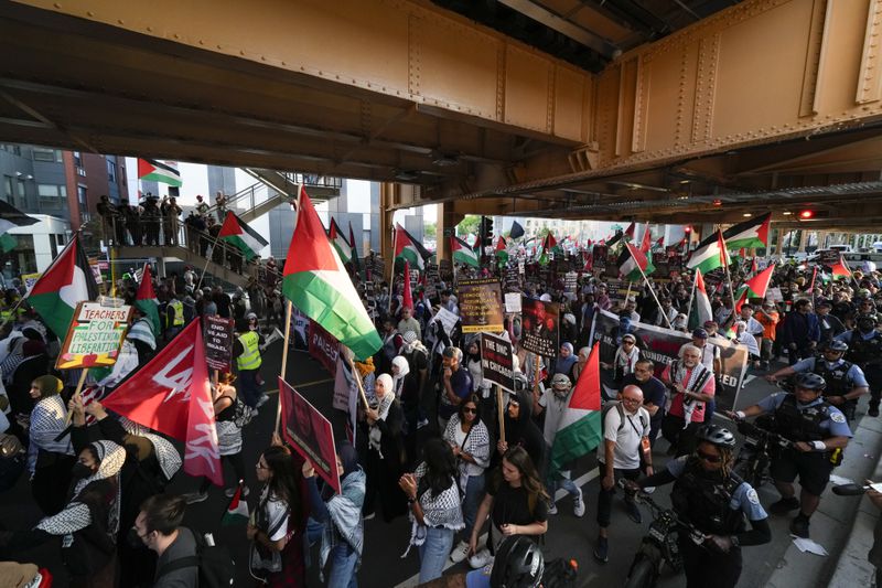 Protesters march during a demonstration outside the Democratic National Convention Wednesday, Aug. 21, 2024, in Chicago. (AP Photo/Julio Cortez)