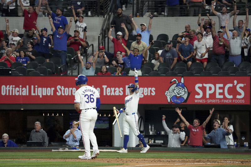 Texas Rangers' Josh Jung, back center, and fans celebrate a walk-off grand slam by Wyatt Langford (36) off of New York Yankees relief pitcher Clay Holmes during the ninth inning of a baseball game Tuesday, Sept. 3, 2024, in Arlington, Texas. Leody Taveras, Josh Smith and Marcus Semien scored on the play. (AP Photo/Jeffrey McWhorter)