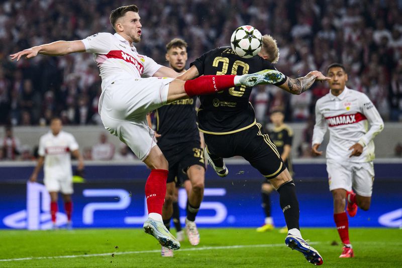 Stuttgart's Ermedin Demirovic, front left, and Prague's Jaroslav, front right, challenge for the ball during the Champions League opening phase soccer match between VfB Stuttgart and AC Sparta Praha in Stuttgart, Germany, Tuesday, Oct. 1, 2024. (Tom Weller/dpa via AP)