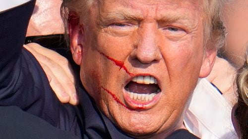 Republican presidential candidate former President Donald Trump reacts following an assassination attempt at a campaign event in Butler, Pa., on Saturday, July 13, 2024. (AP Photo/Gene J. Puskar)