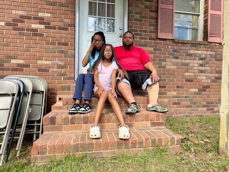 Crystal Taylor, left, with daughter Cassidy Taylor, center, and husband Herbert Taylor at Crystal's parents' house in Sandersville on Monday. (Joe Kovac Jr. / AJC)