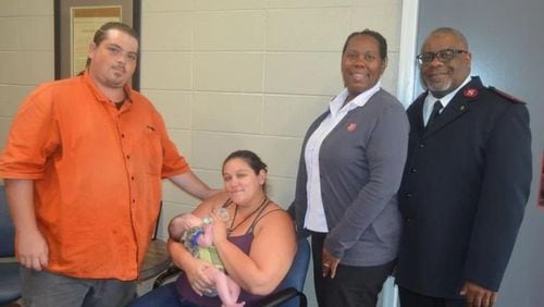 From left, Justin Miller, his wife Britney Miller, holding Baby Rwby, and Salvation Army Capts. Tasha Thomas and Chris Thomas have been caring for the infant since she was born on July 29. It is the first birth for a family staying at the facility while living in one of the recently opened family units at the shelter. (Photo Courtesy of Alan Mauldin)