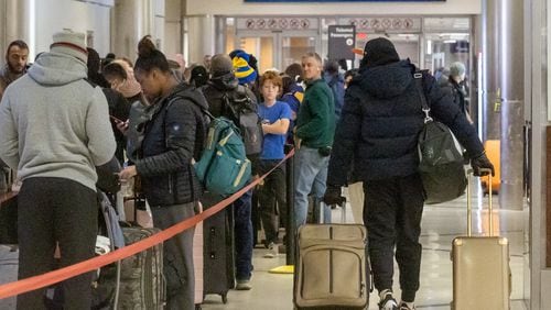 Early morning travelers wait in line to check in at the Southwest counter at at Hartsfield-Jackson International Airport Saturday, Dec. 24, 2022. Those heading out to the airport or elsewhere in metro Atlanta faced temperatures in the single digits Saturday morning. (Photo: Steve Schaefer / steve.schaefer@ajc.com)