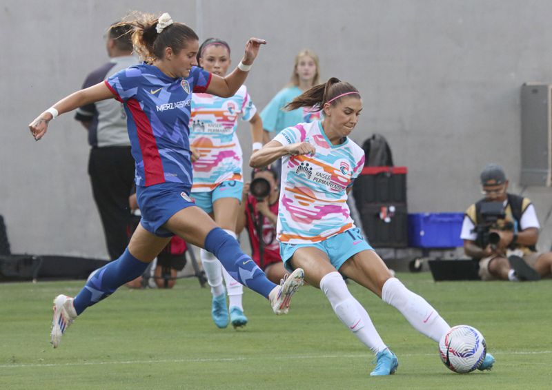 San Diego Wave's Alex Morgan, right, battles for the ball with North Carolina Courages' Malia Berkely during an NWSL soccer on Sunday, Sept. 8 2024, in San Diego. (Sandy Huffaker/The San Diego Union-Tribune via AP)