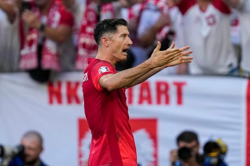 Poland's Robert Lewandowski celebrates after scoring a penalty kick during a Group D match between the France and Poland at the Euro 2024 soccer tournament in Dortmund, Germany, Tuesday, June 25, 2024. (AP Photo/Darko Vojinovic)