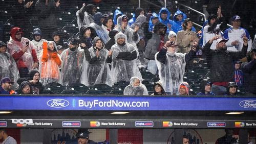 Braves fans celebrate after Matt Olson hit a home run during the fifth inning of the team's baseball game against the New York Mets, Friday, April 28, 2023, in New York. (AP Photo/Bryan Woolston)