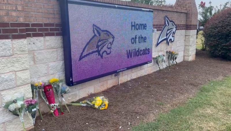 Flowers are placed outside the entrance to Apalachee High School on Thursday, Sept. 5, 2024 in Winder, Ga., a day after deadly shootings at the school. (AP Photo/Sharon Johnson)