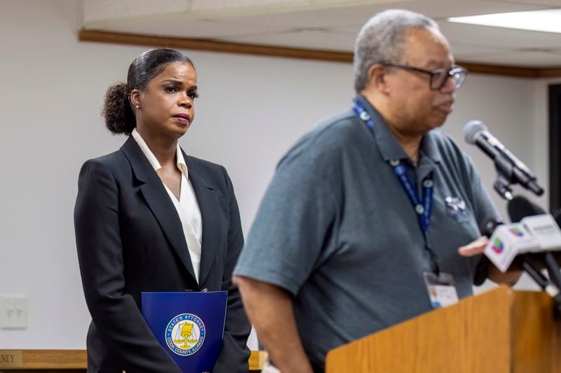 Cook County State's Attorney Kim Foxx, left, listens as Dorval Carter Jr. President of the Chicago Transit Authority speaks to reporters at the Forest Park Village Hall over the shooting death of four people on a Chicago-area transit Blue Line train yesterday morning, Tuesday, Sept. 3, 2024, in Forest Park, Ill. (Tyler Pasciak LaRiviere/Chicago Sun-Times via AP)