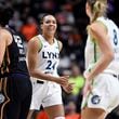 Minnesota Lynx forward Napheesa Collier (24) smiles at forward Alanna Smith (8) during the second half of a WNBA basketball semifinal game against the Connecticut Sun, Friday, Oct. 4, 2024, in Uncasville, Conn. (AP Photo/Jessica Hill)