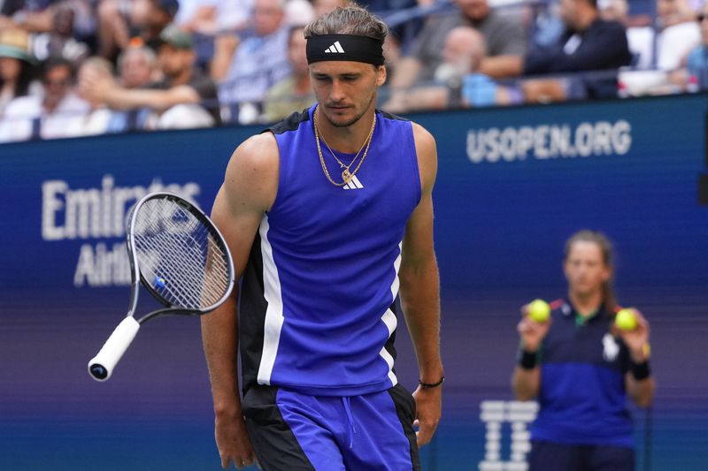 Alexander Zverev, of Germany, bounces his racket off the court in the fourth set against Taylor Fritz, of the United States, during the quarterfinals of the U.S. Open tennis championships, Tuesday, Sept. 3, 2024, in New York. (AP Photo/Kirsty Wigglesworth)