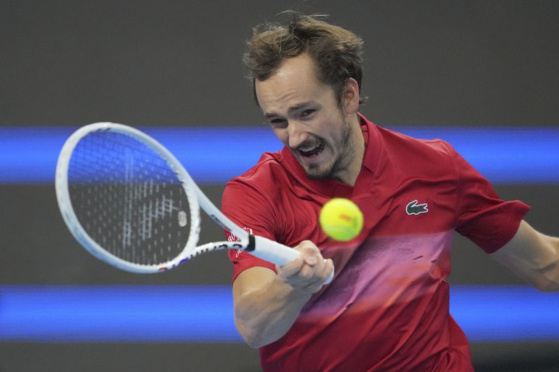 Daniil Medvedev of Russia returns a shot from Carlos Alcaraz of Spain during their men's singles semi-final match for the China Open tennis tournament held at the National Tennis Center in Beijing, Tuesday, Oct. 1, 2024.(AP Photo/Achmad Ibrahim)