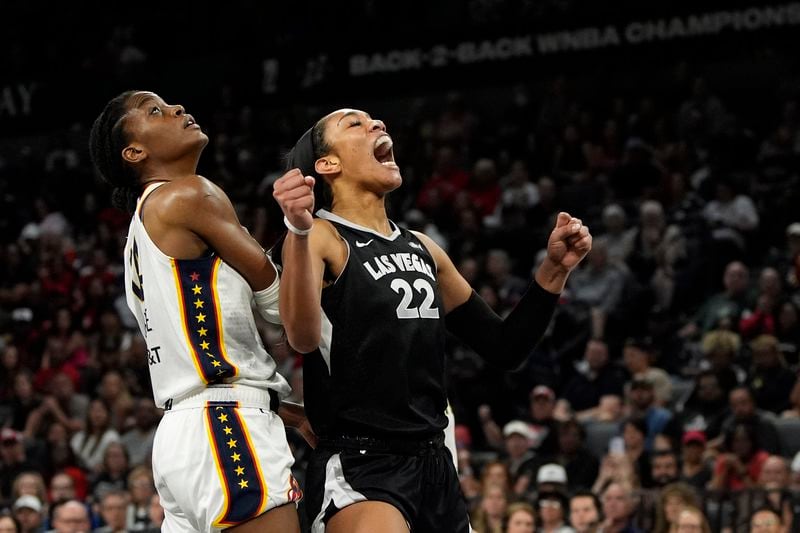 Las Vegas Aces center A'ja Wilson (22) reacts after a play agaist Indiana Fever center Temi Fagbenle (14) during the first half of a WNBA basketball game Saturday, May 25, 2024, in Las Vegas. (AP Photo/John Locher)