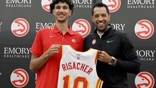 Atlanta Hawks Zaccharie Risacher (left) and General Manager Landry Fields hold up Risacher's jersey during a press conference at Emory Sports Medicine Complex, Friday, June 28, 2024, in Brookhaven. Atlanta Hawks General Manager Landry Fields introduced 2024 NBA Draft selections Zaccharie Risacher (first overall pick) and Nikola Djurisic (43th overall pick) during a press conference.(Hyosub Shin / Hyosub.Shin@ajc.com)