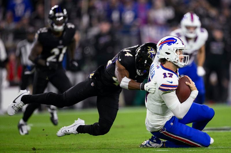 Buffalo Bills quarterback Josh Allen, right, takes a hit from Baltimore Ravens cornerback Marlon Humphrey during the first half of an NFL football game, Sunday, Sept. 29, 2024, in Baltimore. (AP Photo/Nick Wass)