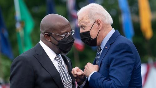 President Joe Biden, right, said he hopes to have a decision by the end of the week on whether to suspend the federal gas tax of 18 cents a gallon. U.S. Sen. Raphael Warnock has been among the biggest supporters seeking a federal gas tax holiday as a way to ease inflation. (Brendan Smialowski/AFP via Getty Images/TNS)