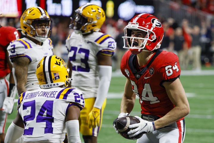 Georgia Bulldogs wide receiver Ladd McConkey (84) celebrates a 22-yard touchdown reception over LSU Tigers cornerback Jarrick Bernard-Converse (24) during the first half of the SEC Championship Game at Mercedes-Benz Stadium in Atlanta on Saturday, Dec. 3, 2022. (Bob Andres / Bob Andres for the Atlanta Constitution)