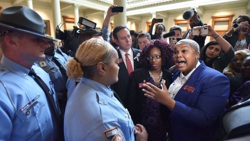 State Rep. Erica Thomas shouts out as Georgia state troopers try to disperse anti-abortion demonstrators after House Bill 481, an anti-abortion “heartbeat bill,” passed on Friday. The Georgia House narrowly voted 92-78, one vote more than needed, to approve legislation that would outlaw most abortions at about six weeks into a pregnancy. HYOSUB SHIN / HSHIN@AJC.COM