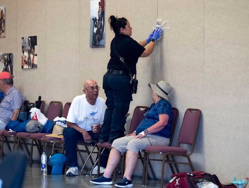 A person is treated for for heat-related illness at the Pikes Peak Regional Airshow at the Colorado Springs Airport on Saturday, Aug. 17, 2024 in Colorado Springs, Colo. (Parker Seibold/The Gazette via AP)