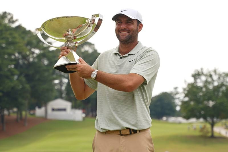 Scottie Scheffler poses with the FedExCup Trophy after the final round of the Tour Championship golf tournament, Sunday, Sept. 1, 2024, in Atlanta. (AP Photo/Jason Allen)