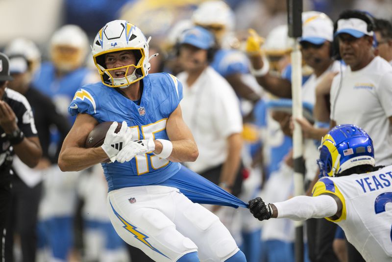 Los Angeles Chargers wide receiver Ladd McConkey runs with the ball as Los Angeles Rams safety Russ Yeast pulls his jersey during an NFL preseason football game, Saturday, Aug. 17, 2024, in Inglewood, Calif. (AP Photo/Kyusung Gong)