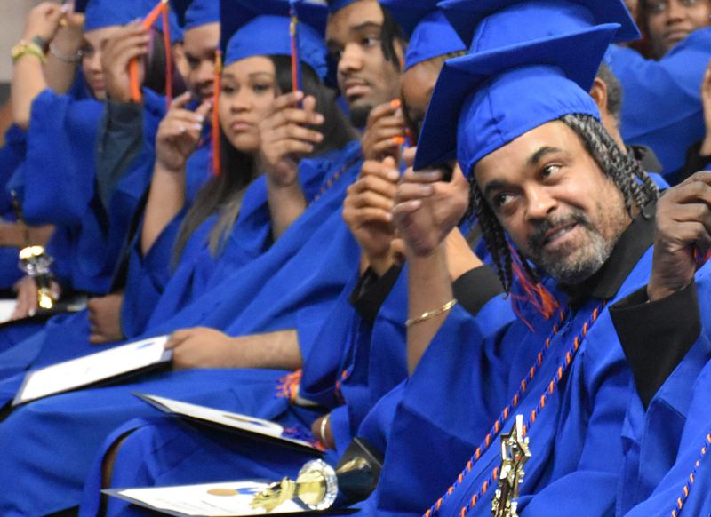 Elmo Desilva, a custodian at Indian Creek Elementary School, turns his tassel as he graduates from the DeKalb County School District's GED program. After obtaining his GED, Desilva was promoted to head custodian at the school. (Courtesy of DeKalb County School District)