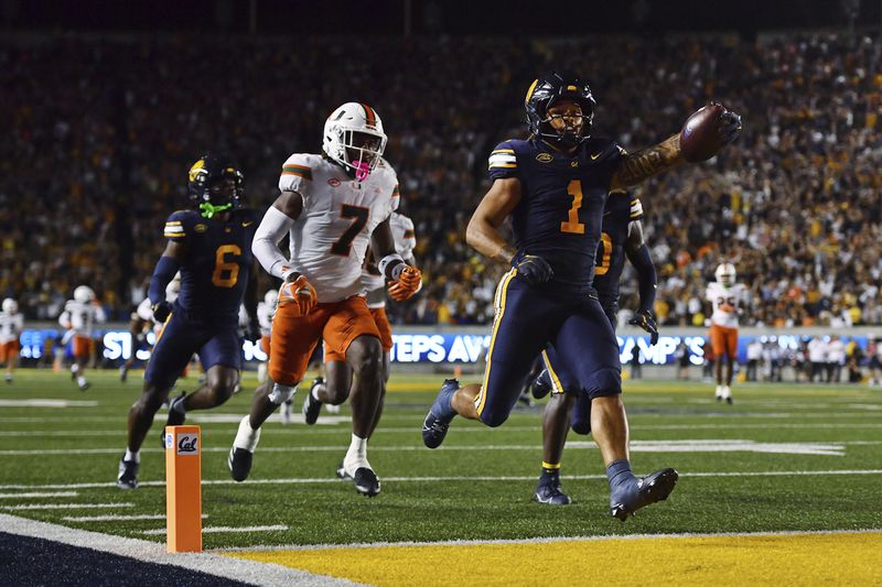 California Golden Bears running back Jaydn Ott (1) scores a 66-yard touchdown against the Miami Hurricanes during the second quarter of their game at Memorial Stadium in Berkeley, Calif., on Saturday, Oct. 5, 2024. (Jose Carlos Fajardo/Bay Area News Group via AP)