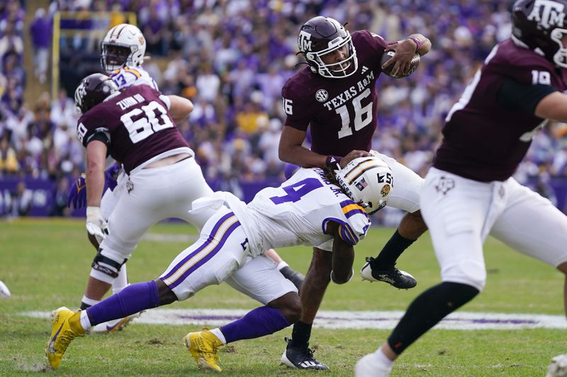 FILE - Texas A&M quarterback Jaylen Henderson (16) is tackled by LSU linebacker Harold Perkins Jr. (4) in the second half of an NCAA college football game in Baton Rouge, La., Saturday, Nov. 25, 2023. (AP Photo/Gerald Herbert, File)