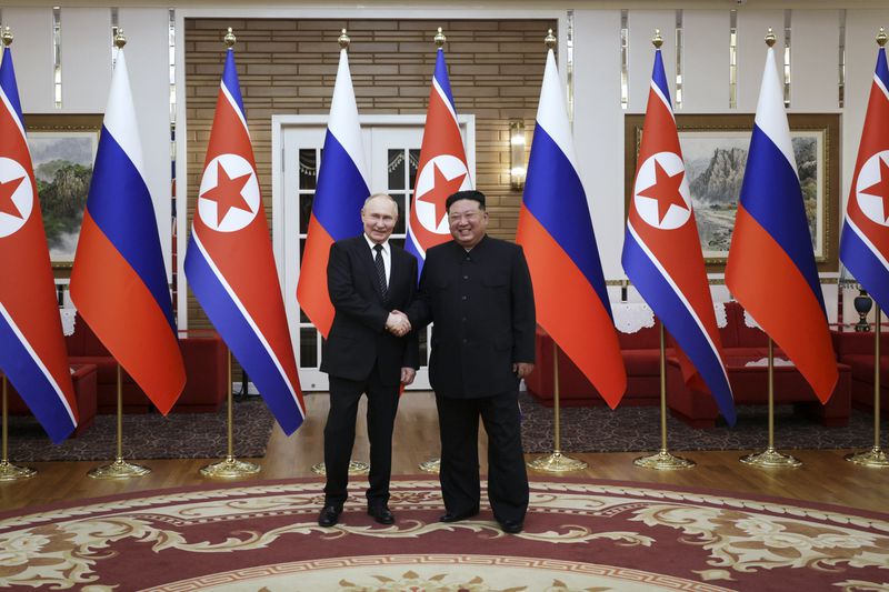 Russian President Vladimir Putin, left, and North Korea's leader Kim Jong Un pose for a photo after the official welcome ceremony in Pyongyang, North Korea, on Wednesday, June 19, 2024. (Gavriil Grigorov, Sputnik, Kremlin Pool Photo via AP)