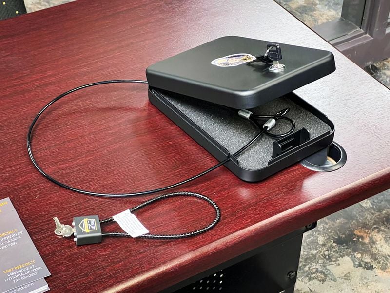 A gun lock (left) and a car safe, both of which the DeKalb County Police Department will hand out for free at a community event Saturday.