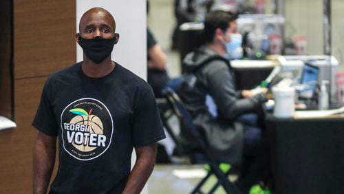 Atlanta Hawks coach Lloyd Pierce was a poll volunteer on Monday, Oct. 12, 2020, - the first day of early voting - at State Farm Arena in downtown Atlanta.