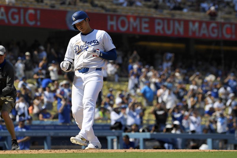 Los Angeles Dodgers' Shohei Ohtani scores after hitting a solo home run during the fifth inning of a baseball game against the Cleveland Guardians, Sunday, Sept. 8, 2024, in Los Angeles. (AP Photo/Mark J. Terrill)