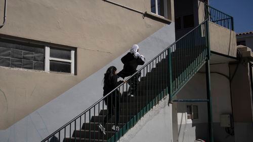 Students run up a flight of stairs as they make their way to class at Ibn Khaldoun, a private Muslim school, in Marseille, southern France, Thursday, April 18, 2024. Brought into the international spotlight by the ban on hijabs for French athletes at the upcoming Paris Olympics, France’s unique approach to “laïcité” — loosely translated as “secularism” — has been increasingly stirring controversy from schools to sports fields across the country. (AP Photo/Daniel Cole)