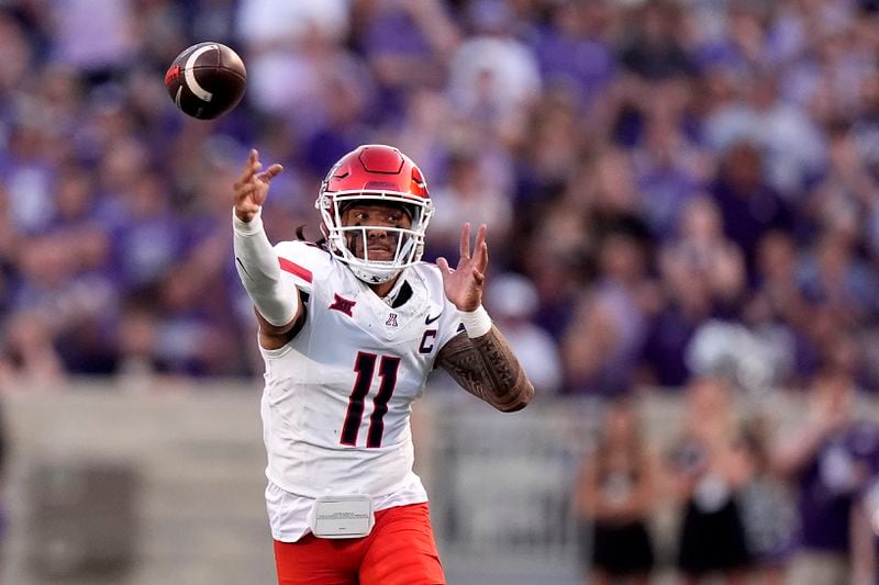 Arizona quarterback Noah Fifita passes the ball during the first half of an NCAA college football game against Kansas State Friday, Sept. 13, 2024, in Manhattan, Kan. (AP Photo/Charlie Riedel)