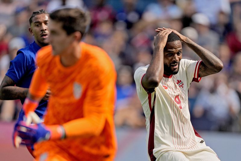 Canada forward Cyle Larin (9) reacts after missing a goal attempt during the first half of an international friendly soccer game against United States, Saturday, Sept. 7, 2024, in Kansas City, Mo. (AP Photo/Charlie Riedel)