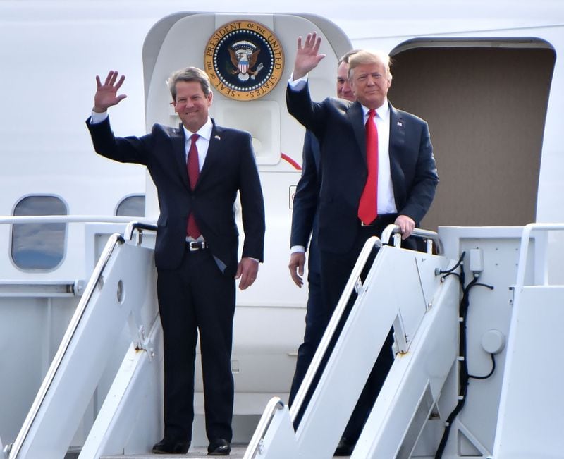 GOP gubernatorial candidate Brian Kemp and President Donald Trump wave from Air Force One as President Donald J. Trump arrives during President Donald J. Trump's Make America Great Again Rally to support Brian Kemp at Middle Georgia Regional Airport in MaconSunday, November 4, 2018. HYOSUB SHIN / HSHIN@AJC.COM
