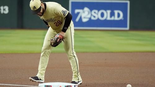 Arizona Diamondbacks third baseman Eugenio Suárez watches the ball bounce off third base for an infield single by San Francisco Giants' Heliot Ramos during the first inning of a baseball game Tuesday, Sept. 24, 2024, in Phoenix. (AP Photo/Ross D. Franklin)