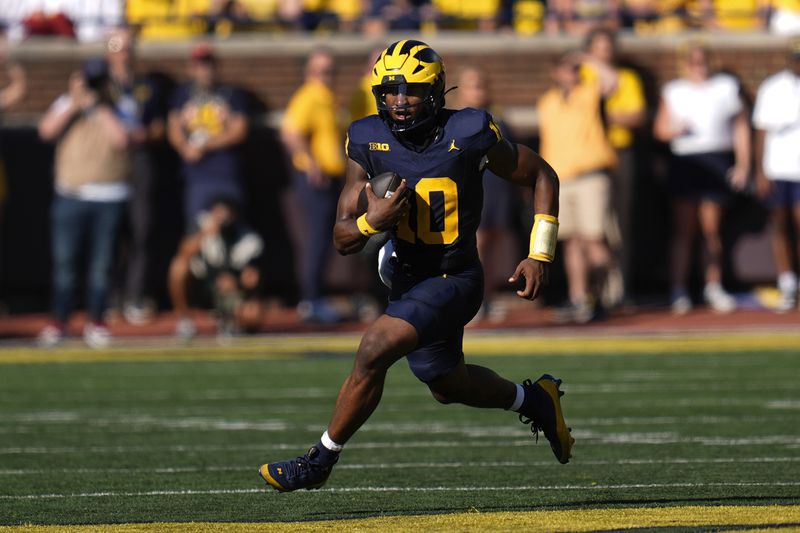 Michigan quarterback Alex Orji runs for yardage against Southern California in the first half of an NCAA college football game in Ann Arbor, Mich., Saturday, Sept. 21, 2024. (AP Photo/Paul Sancya)