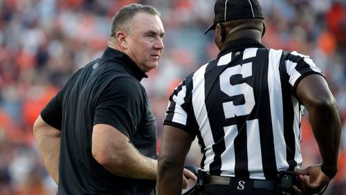 Georgia State coach Shawn Elliott talks with an official during the second half of an NCAA college football game against Auburn Saturday, Sept. 25, 2021, in Auburn, Ala. (AP Photo/Butch Dill)